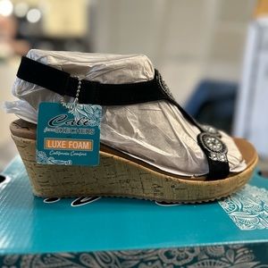 the black BEVERLEE Date Glam wedge sandal by Skechers